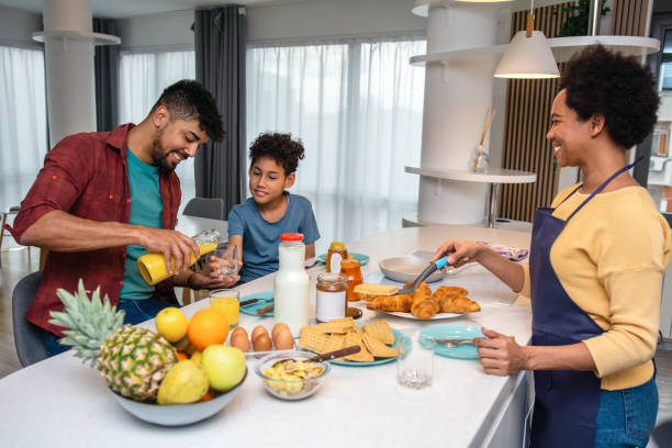 istock Happy black family having breakfast in the kitchen 1391268005