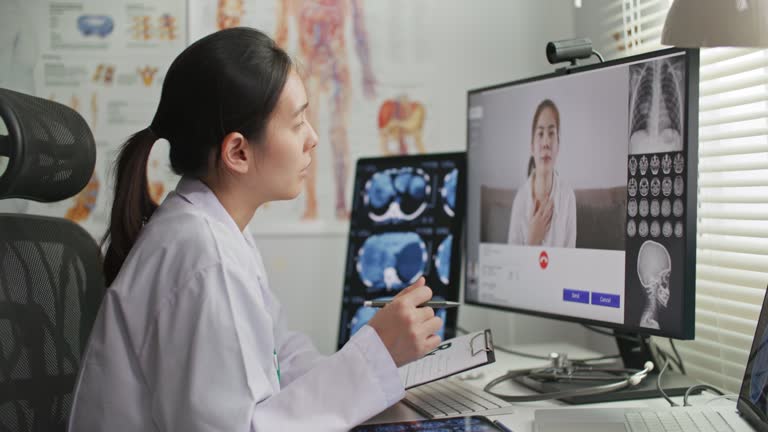 Female doctor talking with her patient remotely via telemedicine from her medical office