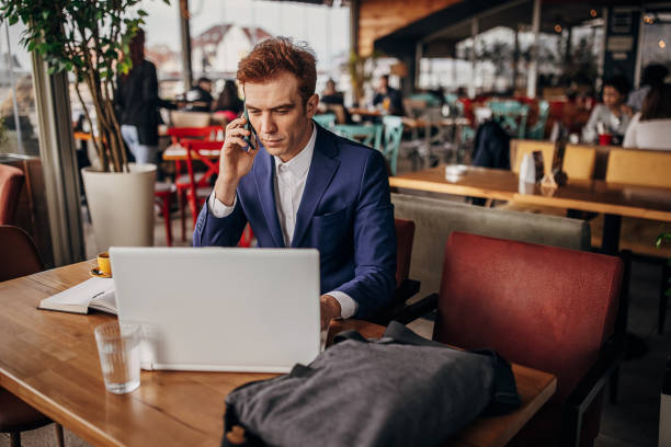istock Businessman using laptop in cafe 1391270455