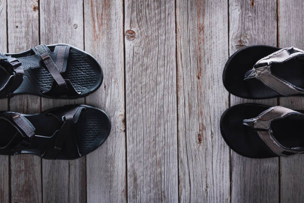 istock Summer flip flops and sandals on wooden background. Accessory. Copy space. Selective focus. 1391270566
