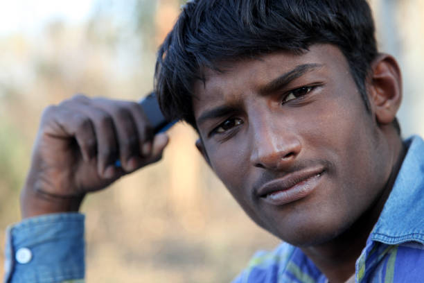 Young  men of Indian ethnicity portrait close up outdoor in nature.