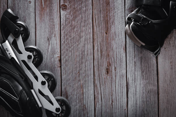 Inline skates on wooden background. Roller. Copy space. Selective focus.