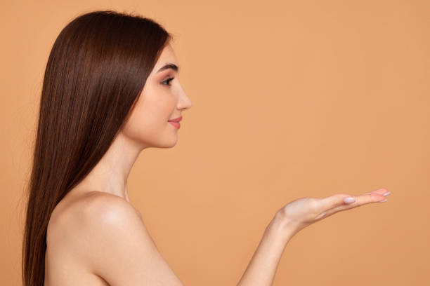 istock attractive young woman holding on palm copy space 1391271955