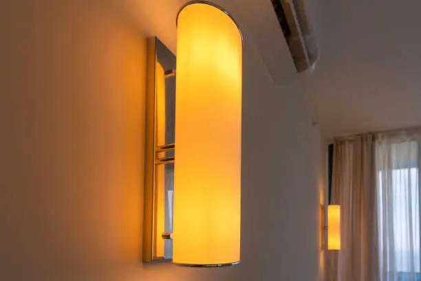 Close-up of the switched-on lamps with orange light on the wall