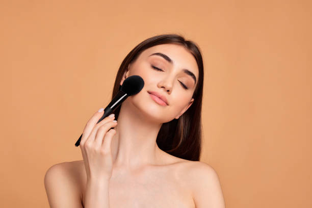 istock model applying powder with make-up brush 1391272316