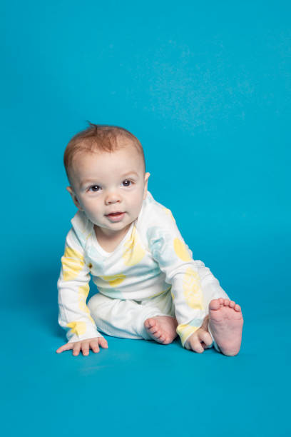 istock Happy Seven Month Old Baby Boy on Blue 1391273539