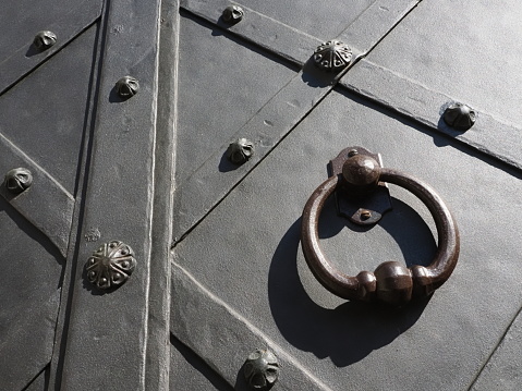 Beautiful, antique, forged door with a round handle. photo taken in Krakow on the main square.