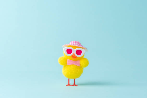 istock Funny chicken with hat on blue background. Spring Easter minimal concept. 1391277243