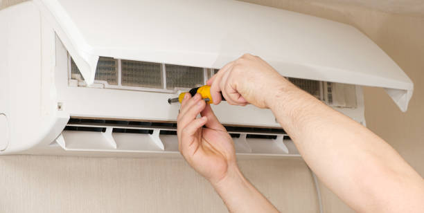 istock The master unscrews the air conditioner cover with a screwdriver. 1391278343