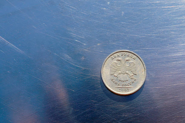 istock Two Russia ruble coin on scratched metallic background. 1391278367