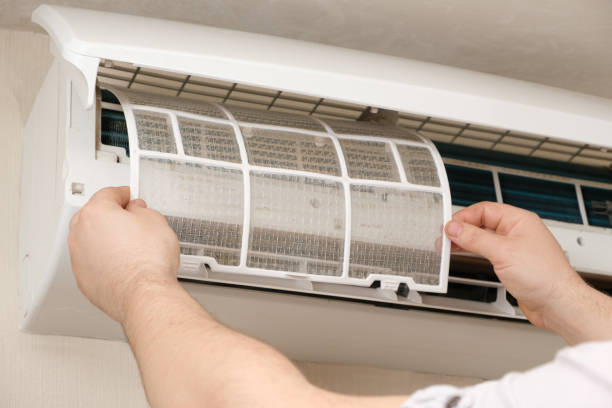 istock The master installs a clean air conditioner filter after purging. 1391278476