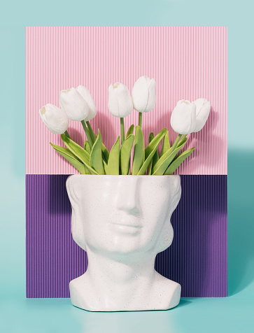 Stone head sculpture with tulip flowers on a pink and purple background. Spring, summer artistic concept.