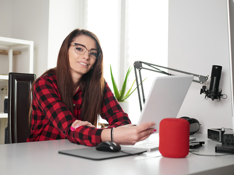 young woman working at home on desktop pc and digital tablet