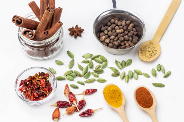 istock Allspice in metal bowl and cinnamon sticks in jar. 1391280886