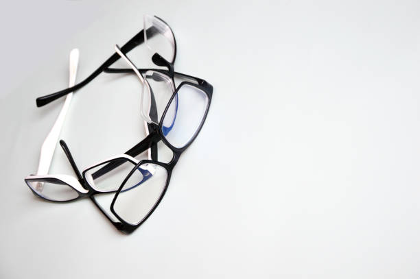 istock Glasses in a black and white frame, randomly lying on a white background. Accessories for vision correction. Optics. 1391282094