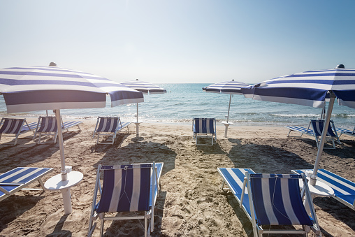 Beaches in Italy are prepared and ready for tourist to come to visit the country.  Laghi Alimini, Puglia, Italy