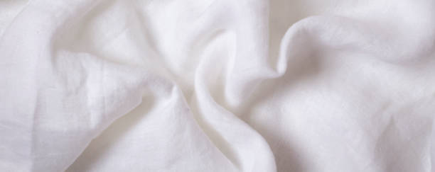 istock White crumpled linen fabric texture background. Natural linen canvas organic eco textiles background. Top view 1391288054