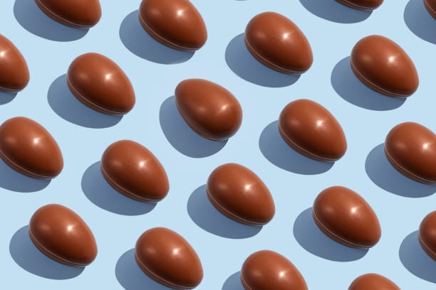 istock Chocolate eggs. Easter eggs. Seamless pattern of whole chocolate eggs on a blue background. Easter sweet chocolate background 1391289740