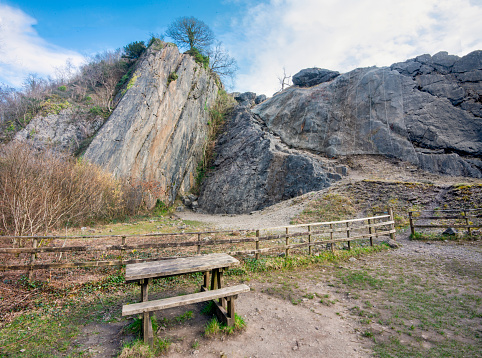 Seating area,near the large impressive high limestone rock and cliff promontory,impressive South Wales landmark,used by rock climbers,on the Sychryd waterfalls trail,next to car park,near Powys.