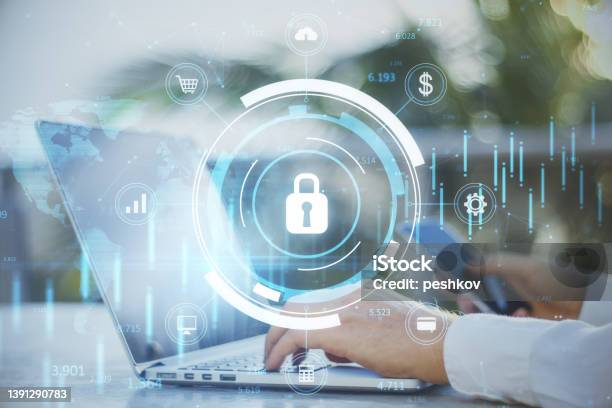 Close Up Of Businessman Hand Using Laptop Keyboard And Smartphone With Glowing Blue Padlock Hologram With Forex Chart And Map On Blurry Outdoor Background Secure And Online Safety Concept Double Exposure Stock Photo - Download Image Now