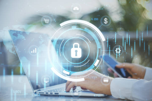 close up of businessman hand using laptop keyboard and smartphone with glowing blue padlock hologram with forex chart and map on blurry outdoor background, secure and online safety concept. double exposure. - cloud computing cloud computer computer keyboard imagens e fotografias de stock