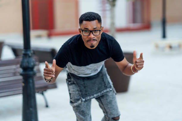 istock African man with glasses makes pointing fingers gesture 1391290873