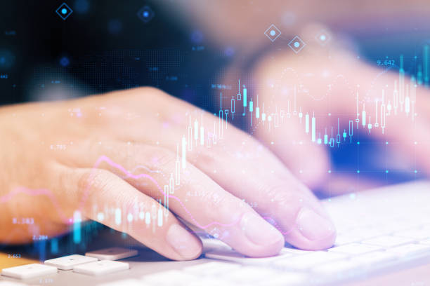 istock Close up of hands using keyboard with glowing forex chart on blurry background. Fintech, digital transformation and finance concept. Double exposure. 1391290884