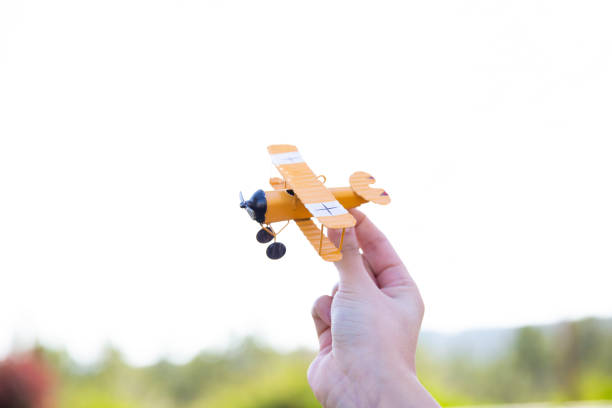 istock Hand holding a toy plane. 1391293150