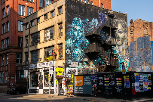 Manchester, England - United States - March 23rd, 2022: Old storefront in  Manchester on a sunny Spring day.