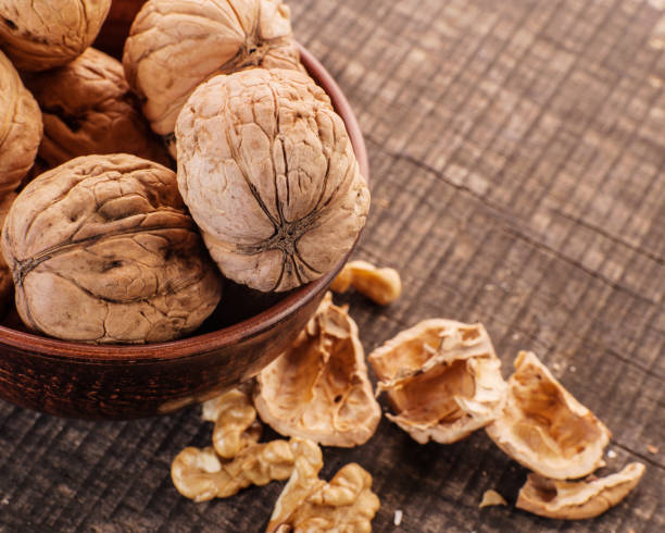 istock Walnuts. Nuts of walnuts.Tongs for cutting nuts. 1391293876