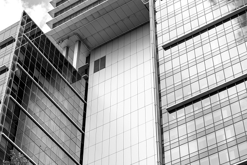 Closeup black and white modern office buildings, skyscrapers, background with copy space, full frame horizontal composition