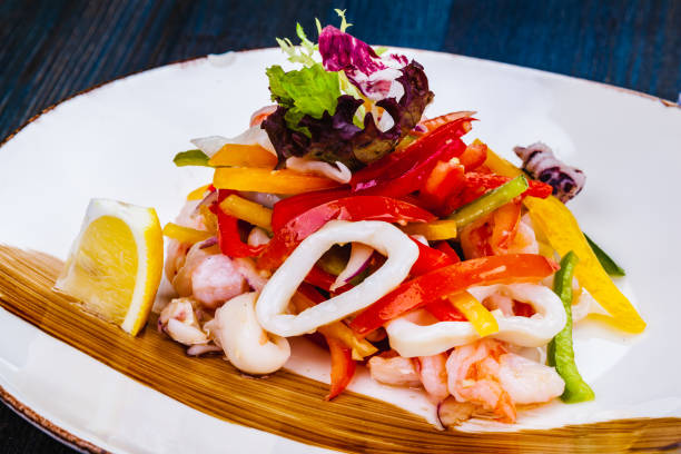 istock Salad with squid, bell pepper and onion on white plate 1391295348