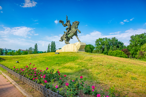 Park and the equestrian statue of Alexander Suvorov (by Valentin and Victor Artamonovs, 1979) in Tiraspol, Transnistria, Moldova on a sunny day. General Alexander Suvorov founded the city of Tiraspol in 1792.