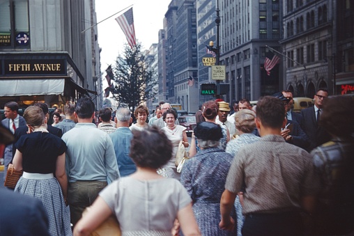 Manhattan, New York City, USA, 1965. Street scene. People cross a traffic light at the corner of 5th Avenue and W 42 St. in downtown Manhattan.