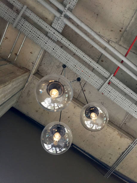 istock Electric lamps with Edison lightbulb hanging on the concrete ceiling 1391297319