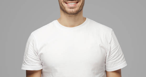 istock Young smiling optimistic man in blank white t-shirt 1391298365