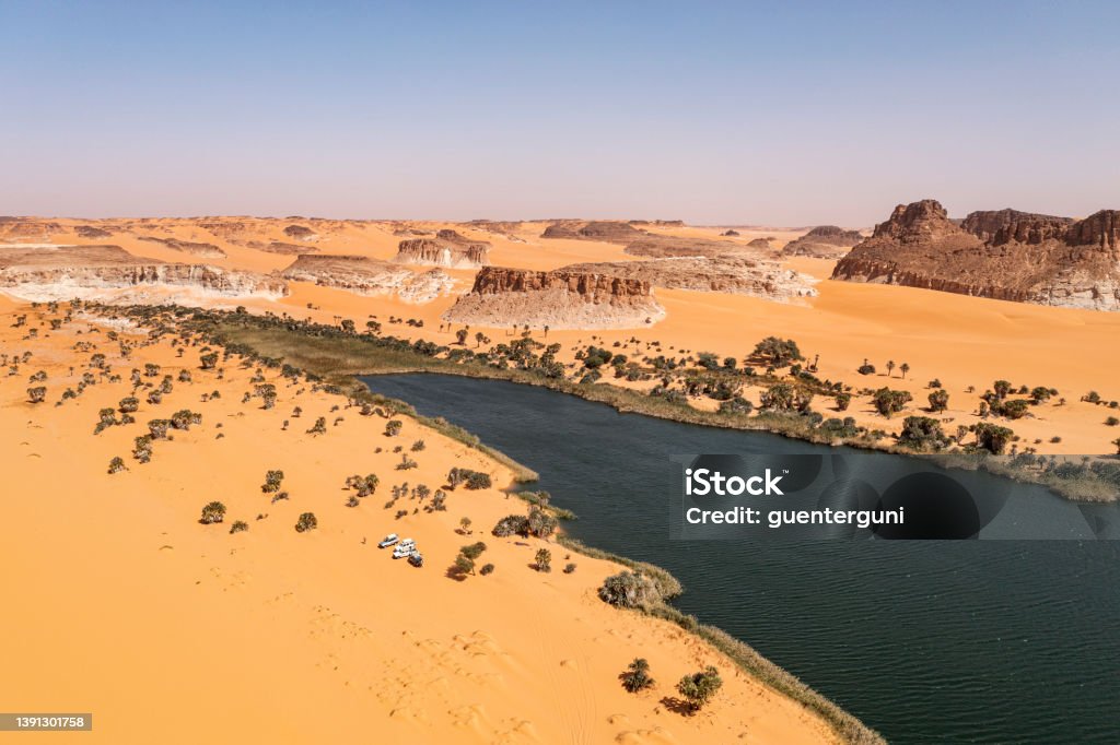 Legendary Ounianga Serir Lake in the Ennedi region, Sahara, Chad Aerial view of the Ounianga Sérir Lake, one of the legendary Lakes of Ounianga in North-Eastern Chad. 

These remote lakes are definetely one of the greatest natural wonders on our planet. In the middle of the endless Sahara Desert, actually in a basin between the  mountains of Western Tibesti and the Eastern Ennedi massif there is a total of 18 lakes. All togehter the lakes are covering a surface of approx. 20 square kilometers. 

The Lakes of Ounianga were declared as an UNESCO World Heritage site in 2012. Chad - Central Africa Stock Photo