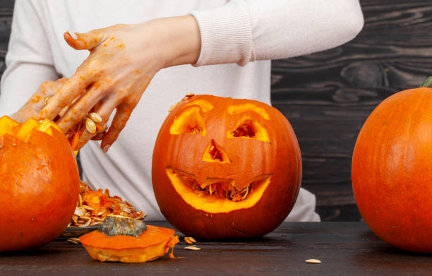 istock preparing an orange pumpkin for Halloween celebration 1391302808