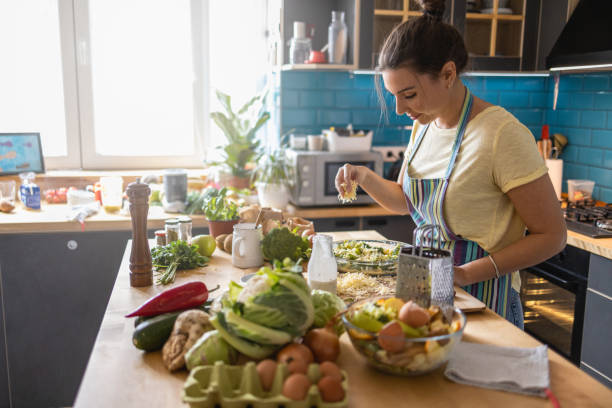 istock Woman adding cheese to Lunch 1391305723