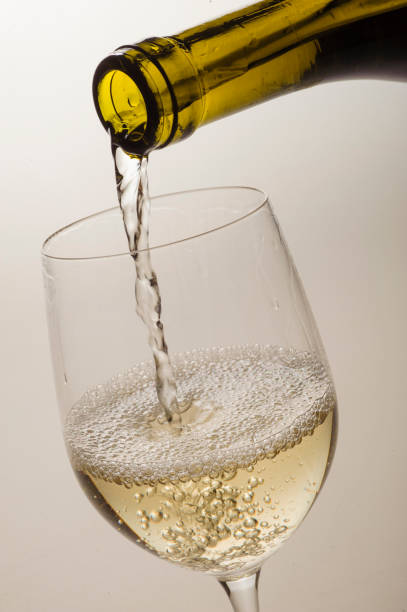istock white wine is poured into a special glass on a light background in the studio close-up without a person 1391307224
