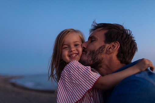 Dad loves and kisses his little daughter