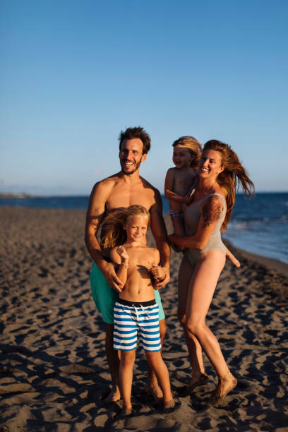 istock Family on the beach during summer 1391309582
