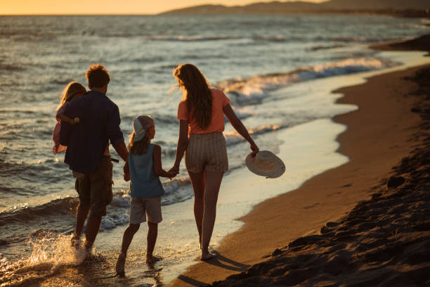 istock Parents and children on beach 1391309602