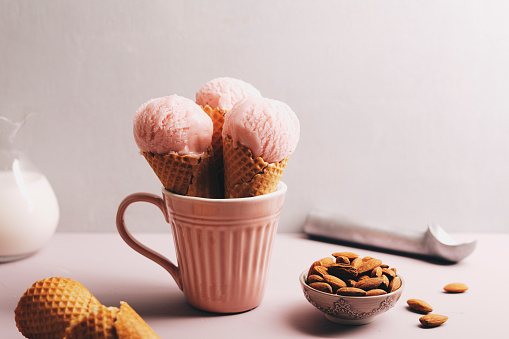 Dairy free ice cream scoops with almond and spoon.