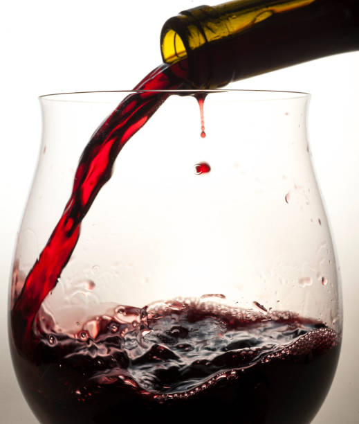 istock red wine is poured into a special glass on a light background in a studio without people close-up 1391310751