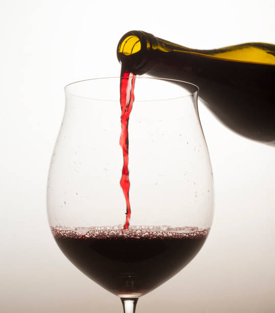 istock red wine is poured into a special glass on a light background in a studio without people close-up 1391310757