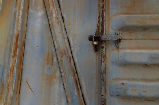 istock Metal locked padlock at Vintage railroad container doors gates. 1391315143