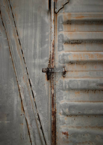 istock Metal locked padlock at Vintage railroad container doors gates. 1391315148