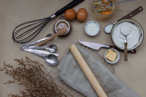 istock Ingredients and kitchen items for baking cakes. flour, eggs, butter, milk and honey on light brown table. Baking background. 1391315188