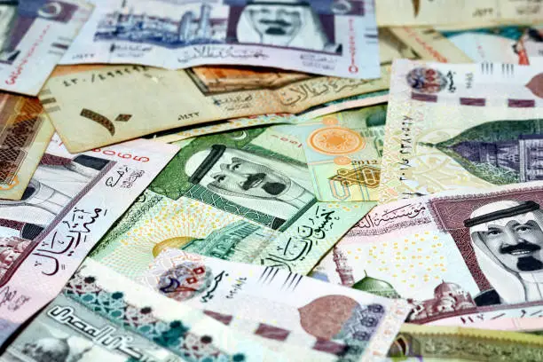 Egyptian pounds banknotes money of 100 LE and 200 LE with Saudi Arabia riyals money banknotes of 1,5,10,20,50 and 100 SAR, selective focus of Saudi Arabia money riyals and Egyptian money exchange rate